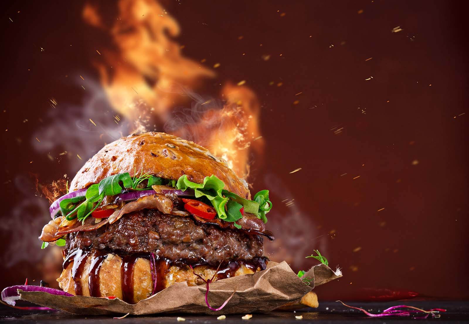 Delicious hamburger with fire flames - The Butcher Shop, Inc.